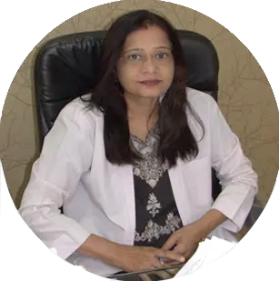 Female doctor in white coat seated at desk – clinic consultation setting