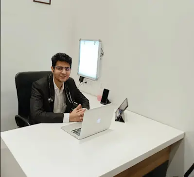 Dr. Sameer Lote- best pulmonologist in Nagpur- seated at a desk