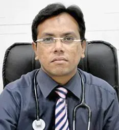 Dr. Vinit Niranjane, a pulmonologist, sitting at his desk with a stethoscope around his neck