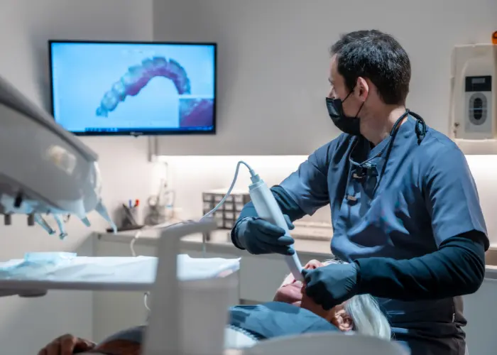 Dentist scanning a patient’s teeth.